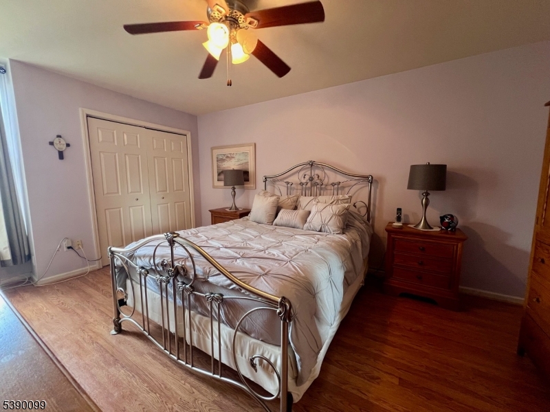 14 River Nutley Nj 07110, Unit F Nutley, NJ 07110 - Photo 12 of 17 a bedroom with a bed and a chandelier