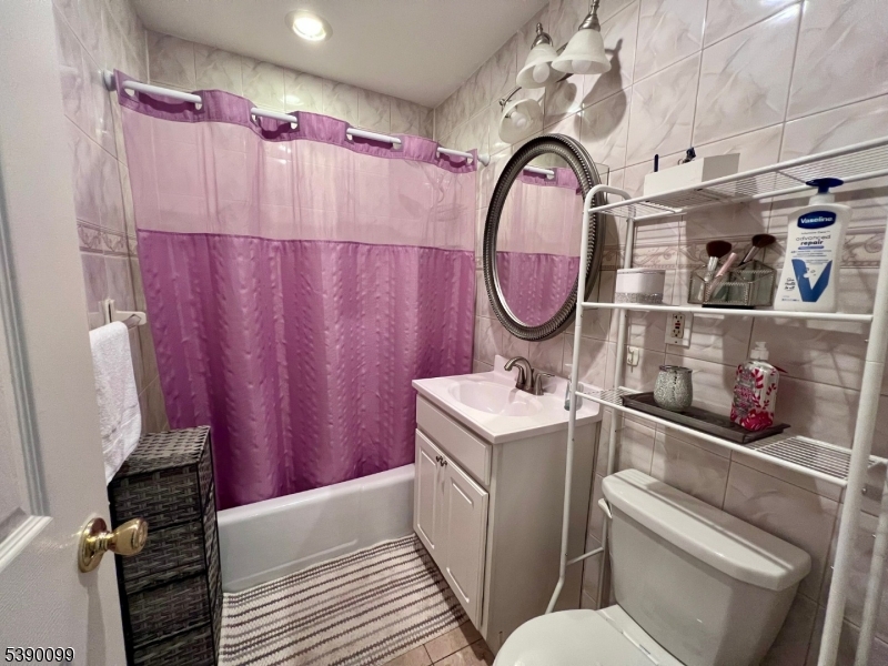 14 River Nutley Nj 07110, Unit F Nutley, NJ 07110 - Photo 13 of 17 a bathroom with a sink a toilet and a shower curtain