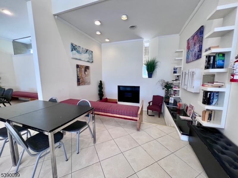 14 River Nutley Nj 07110, Unit F Nutley, NJ 07110 - Photo 17 of 17 a living room with furniture and a flat screen tv