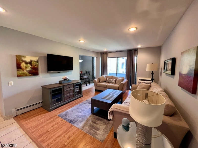 14 River Nutley Nj 07110, Unit F Nutley, NJ 07110 - Photo 2 of 17 a living room with furniture and a flat screen tv