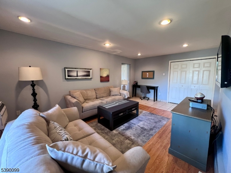 14 River Nutley Nj 07110, Unit F Nutley, NJ 07110 - Photo 3 of 17 a living room with furniture and a wooden floor