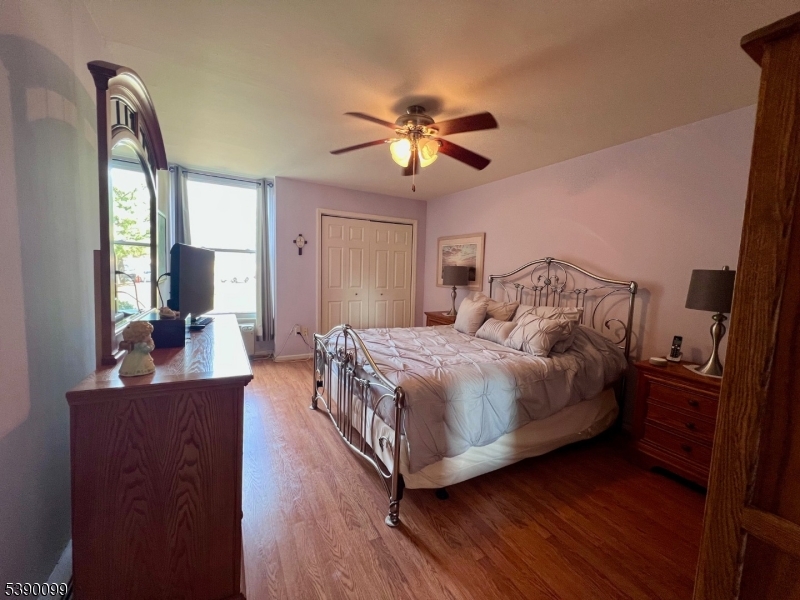 14 River Nutley Nj 07110, Unit F Nutley, NJ 07110 - Photo 10 of 17 a bedroom with a bed and wooden floor