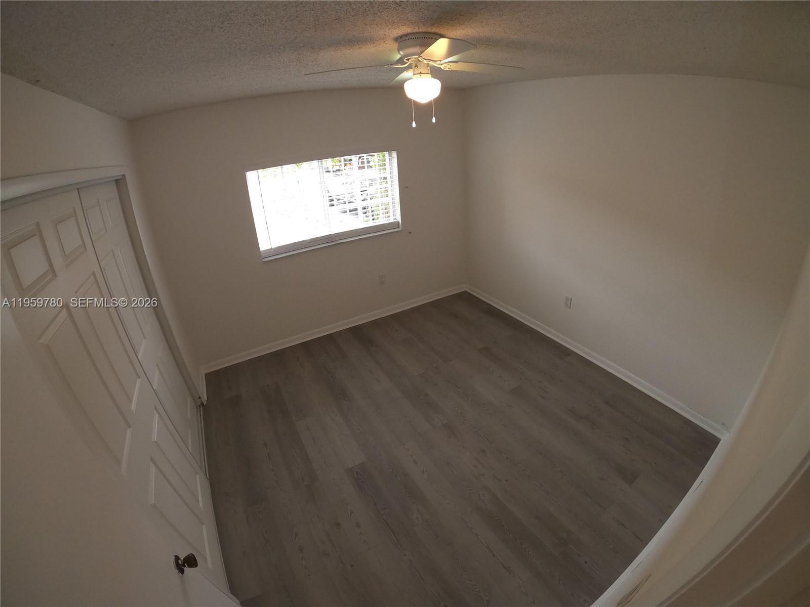 7908 West 34th Lane, Unit 10235 Hialeah, FL 33018 - Photo 3 of 14 an empty room with a window
