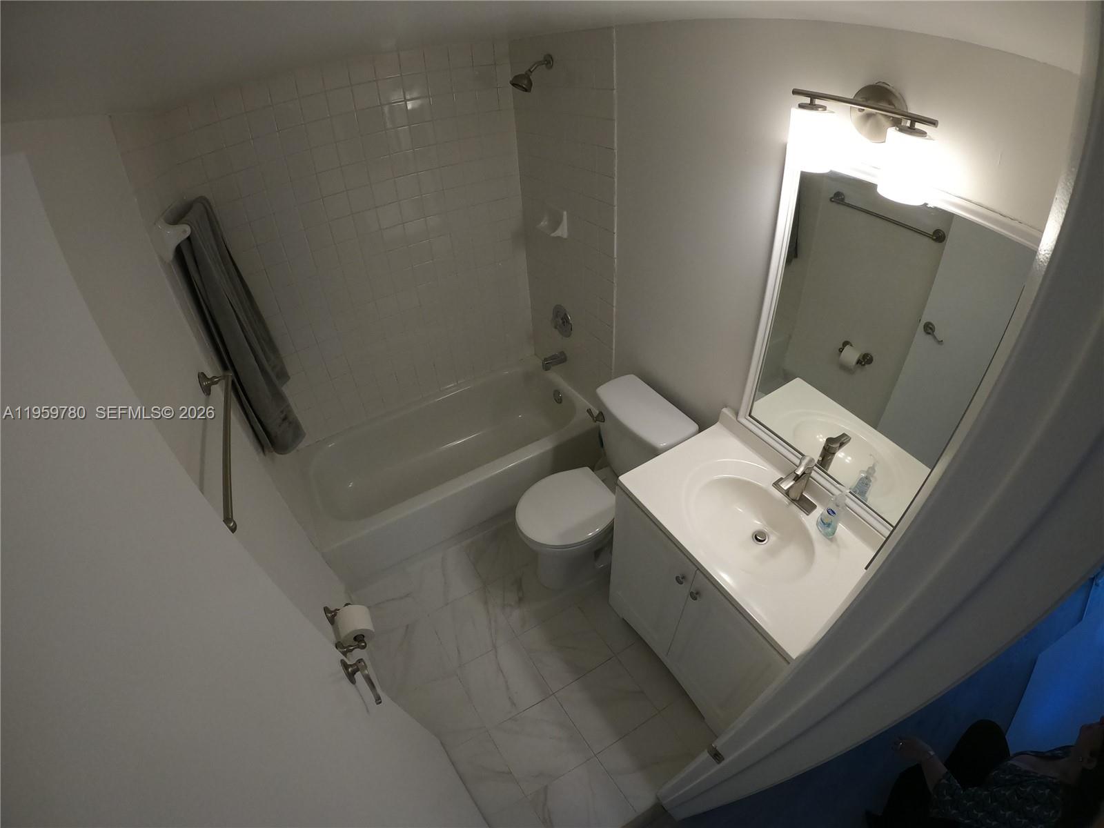 7908 West 34th Lane, Unit 10235 Hialeah, FL 33018 - Photo 4 of 14 a bathroom with a sink a toilet and shower