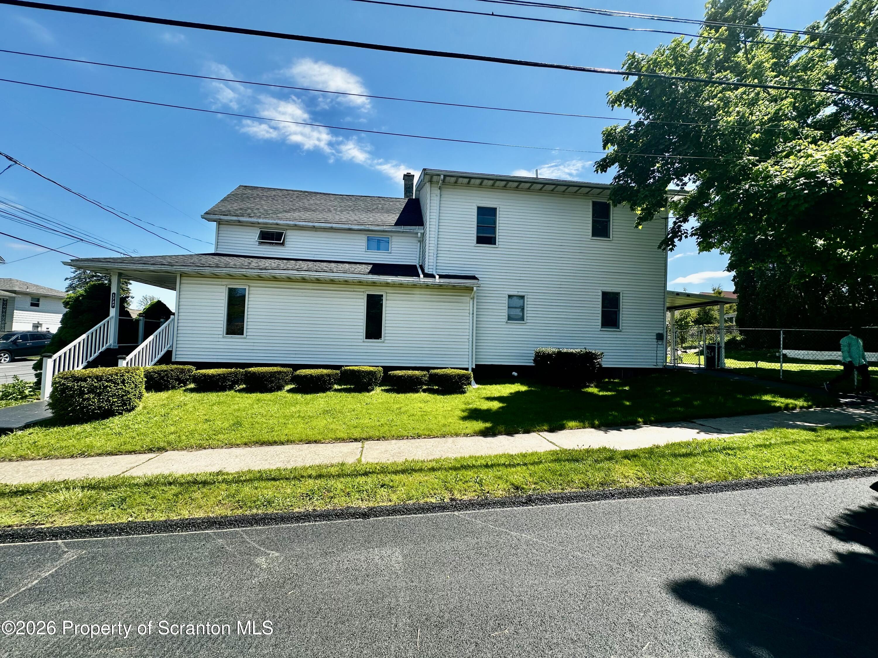 1727 Bulwer Street Scranton, PA 18504 - Photo 4 of 40 a front view of a house with a yard and a garage
