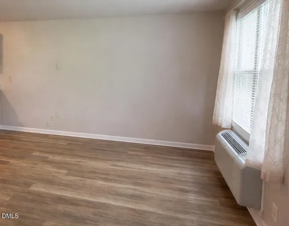 a view of wooden floor and windows in a room
