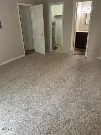 an empty room with mirror and door