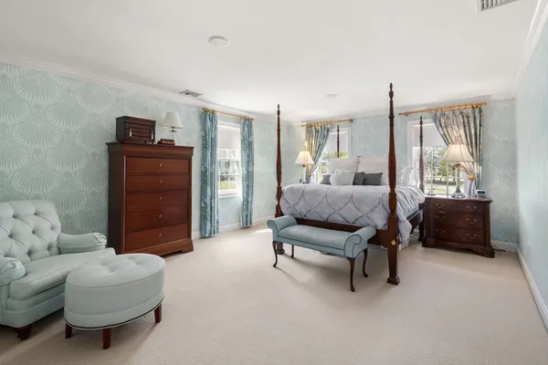 a living room with furniture and a dresser