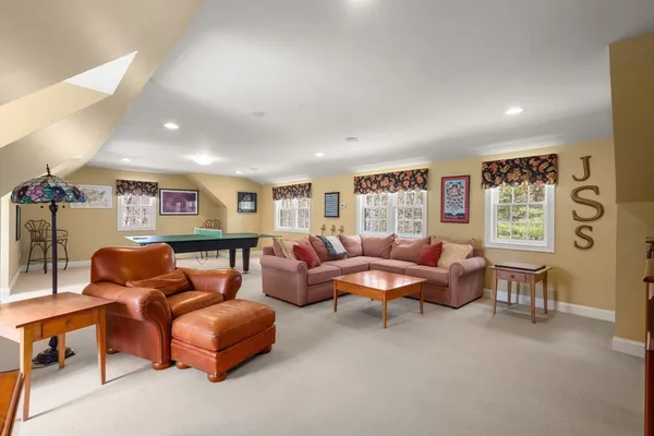 a living room with furniture a rug and a window