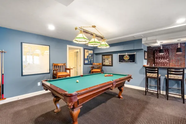 a room with furniture pool table and windows