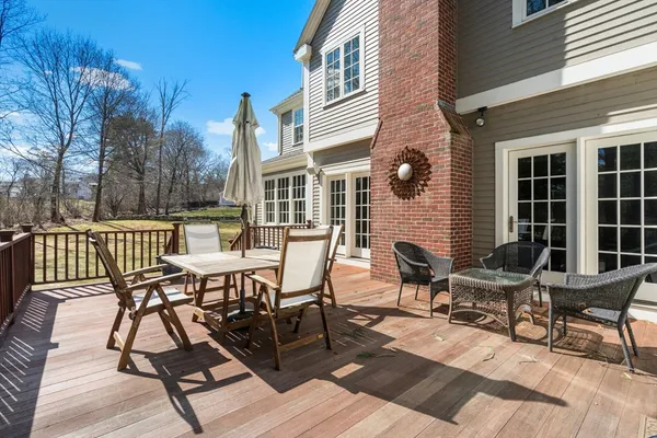 a view of a patio with couple of chairs and a potted plant