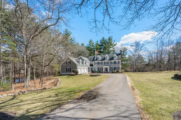 a view of a house with a yard and trees