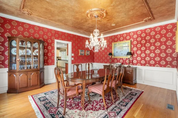 a view of a dining room with furniture and chandelier
