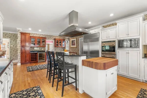 a kitchen with stainless steel appliances granite countertop a stove and a refrigerator