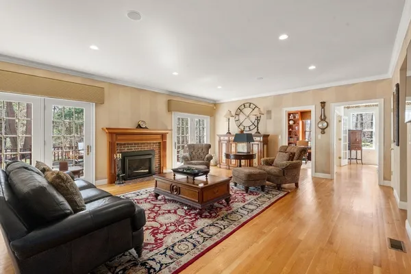 a living room with furniture fireplace and wooden floor