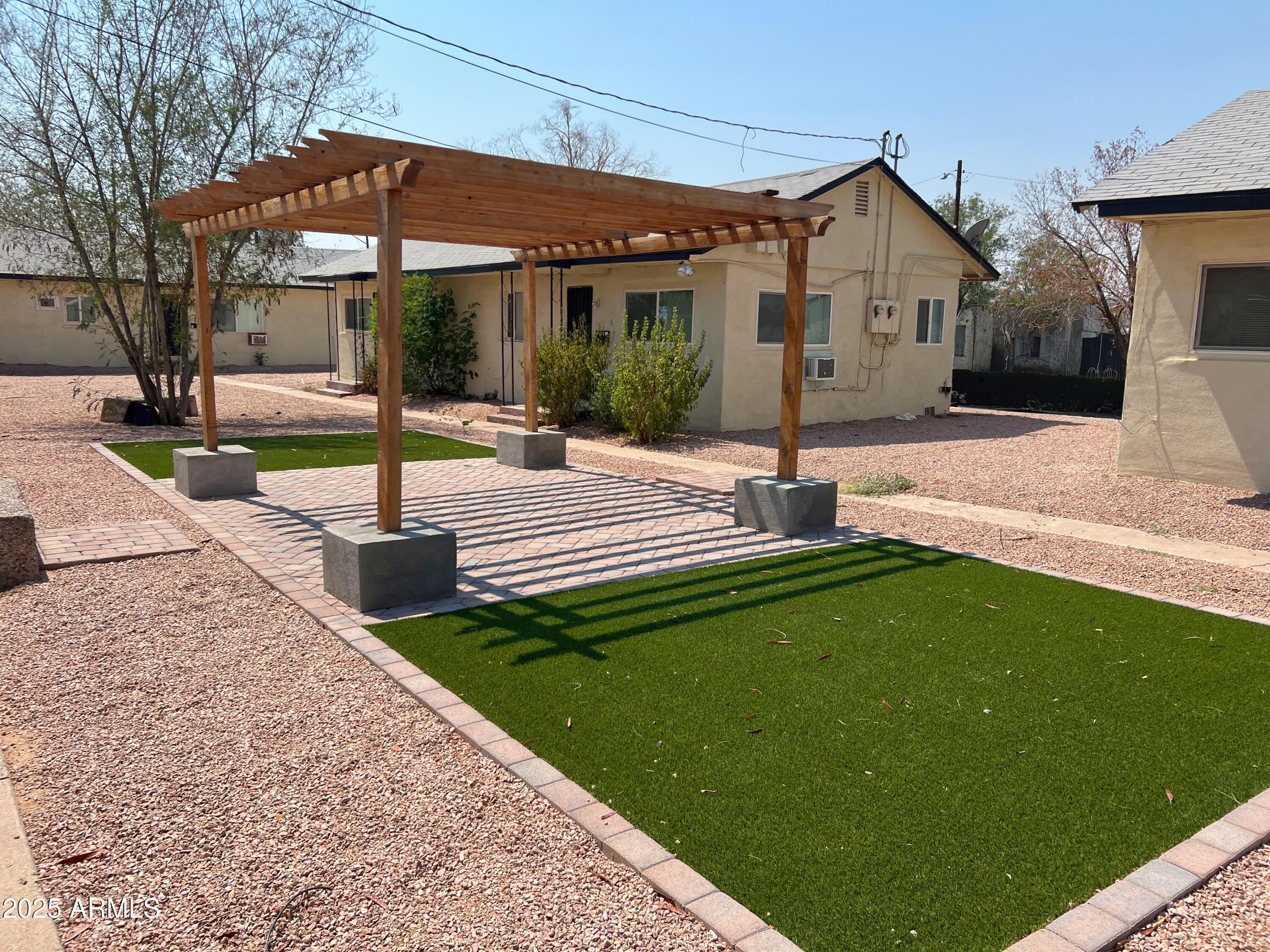 1125 East Devonshire Avenue, Unit 9 Phoenix, AZ 85014 - Photo 1 of 11 a view of a house with backyard and porch