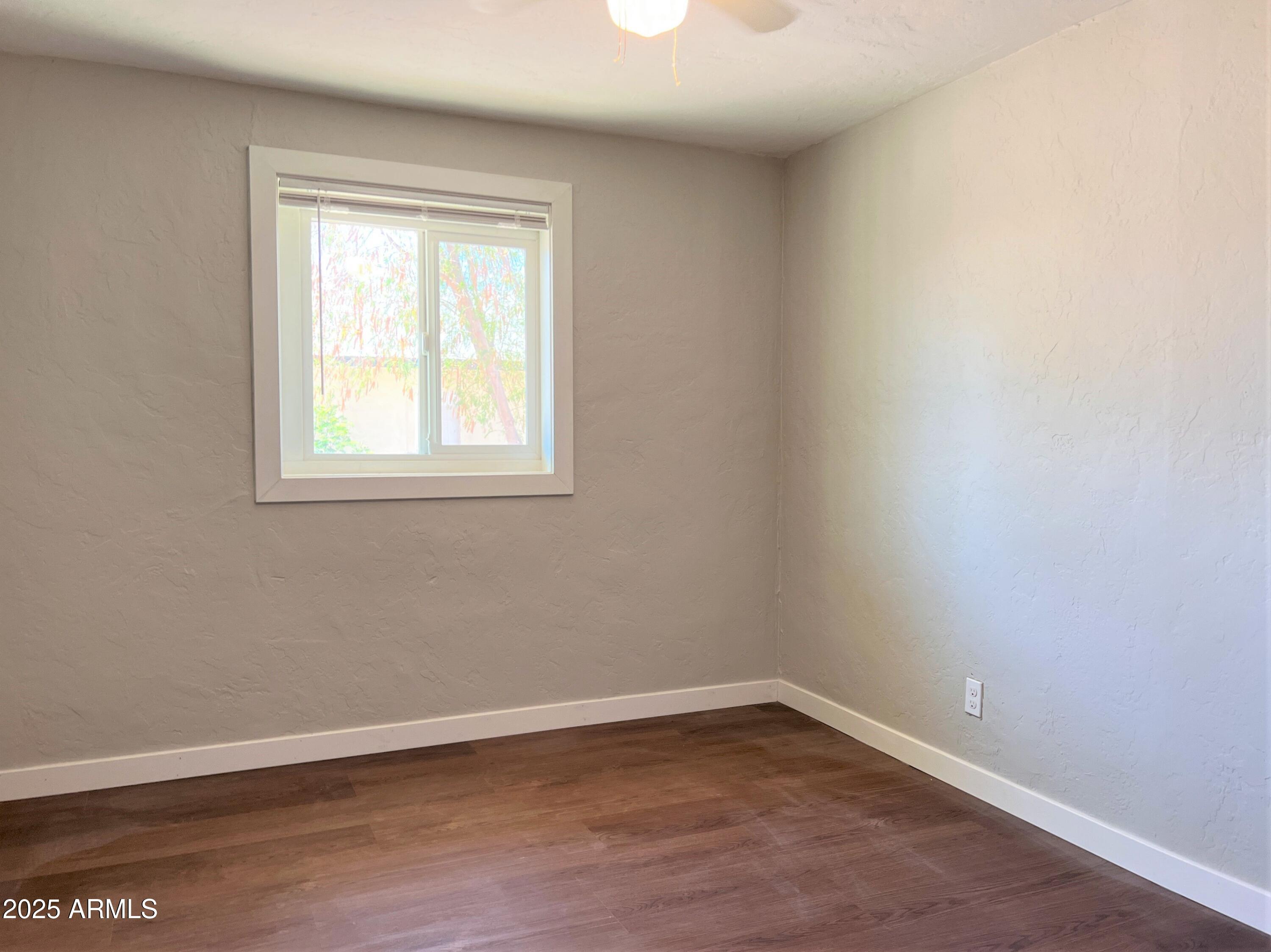 1125 East Devonshire Avenue, Unit 9 Phoenix, AZ 85014 - Photo 8 of 11 an empty room with a window