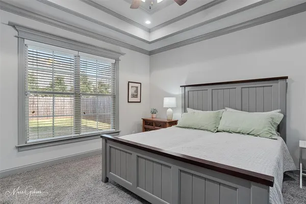 a living room with a bed furniture and a large window