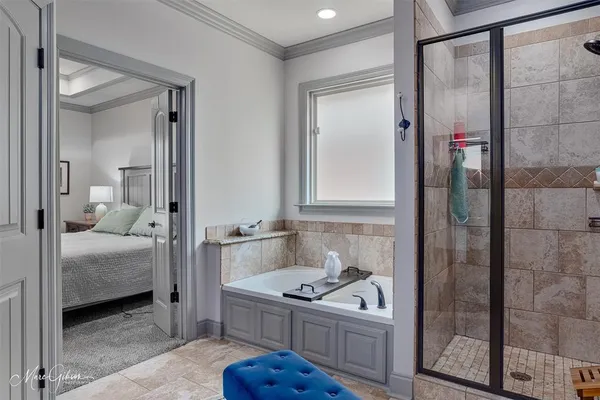a bathroom with a sink vanity granite tub shower and mirror