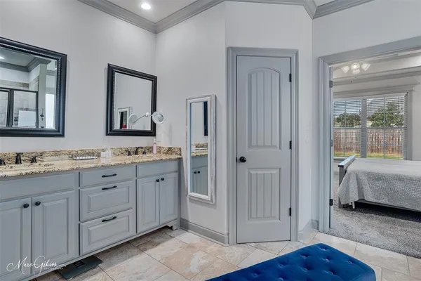 a spacious bathroom with a granite countertop sink and a mirror