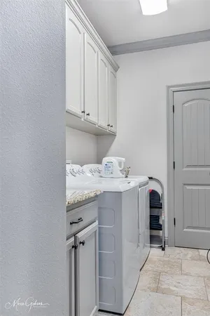 a utility room with a sink dryer and washer
