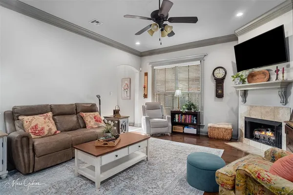 a living room with furniture a flat screen tv and a fireplace