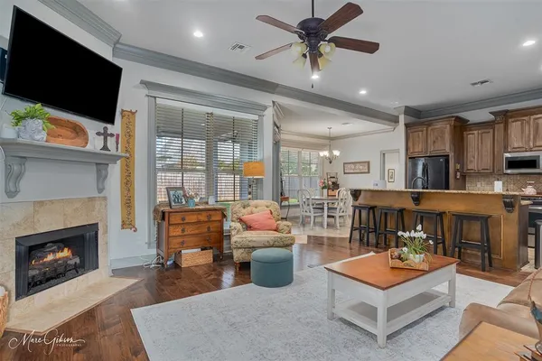 a living room with furniture a flat screen tv and kitchen view