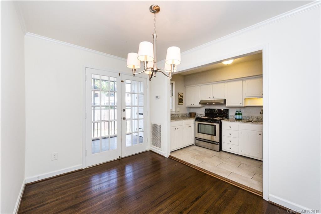 920 McAlway Road, Unit C Charlotte, NC 28211 - Photo 11 of 27 a kitchen with granite countertop white cabinets and white appliances