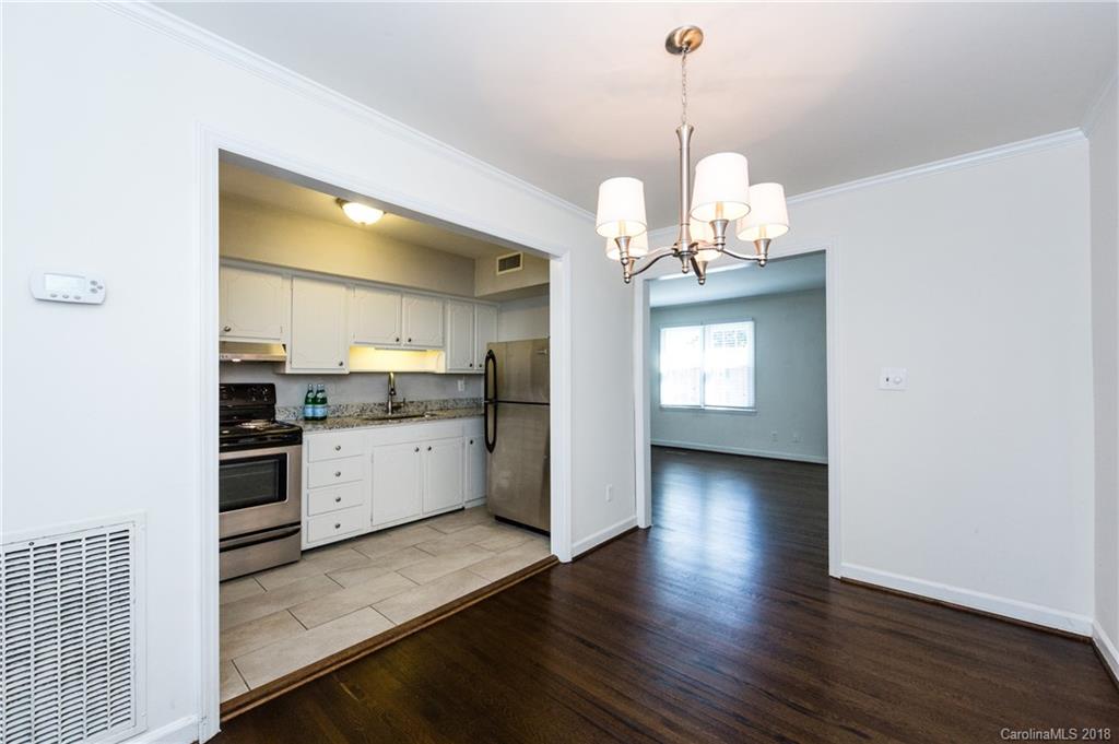 920 McAlway Road, Unit C Charlotte, NC 28211 - Photo 12 of 27 a kitchen with granite countertop a stove a sink and a wooden floor