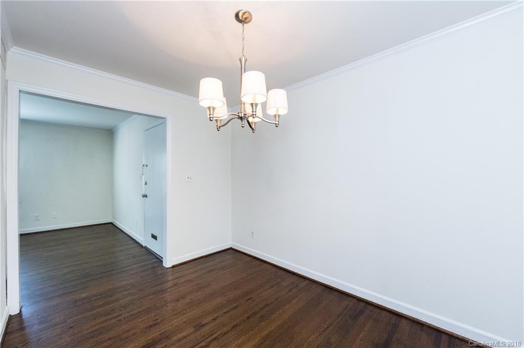 920 McAlway Road, Unit C Charlotte, NC 28211 - Photo 13 of 27 a view of a room with wooden floor and chandelier