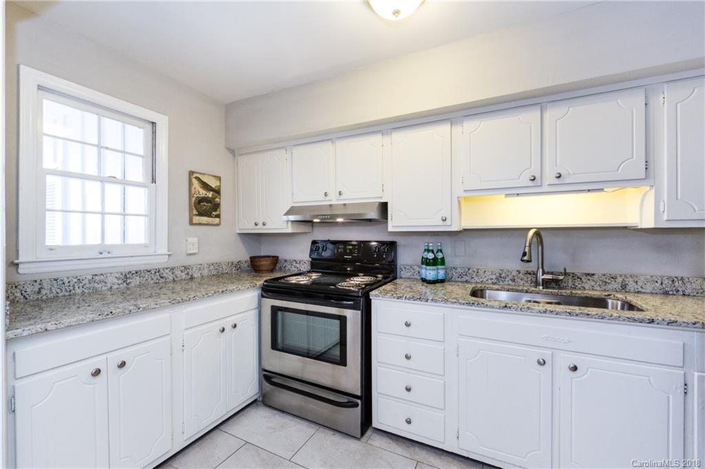 920 McAlway Road, Unit C Charlotte, NC 28211 - Photo 14 of 27 a kitchen with granite countertop white cabinets white appliances and a sink