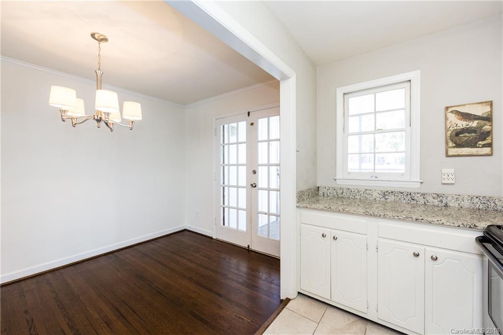 920 McAlway Road, Unit C Charlotte, NC 28211 - Photo 16 of 27 a view of an empty room with a window and wooden floor