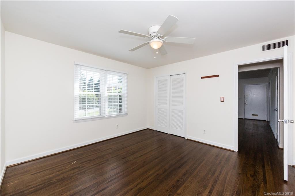 920 McAlway Road, Unit C Charlotte, NC 28211 - Photo 24 of 27 a view of an empty room with wooden floor and a window