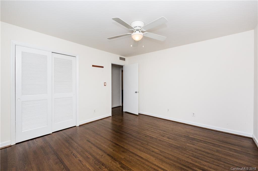 920 McAlway Road, Unit C Charlotte, NC 28211 - Photo 25 of 27 an empty room with wooden floor and fan