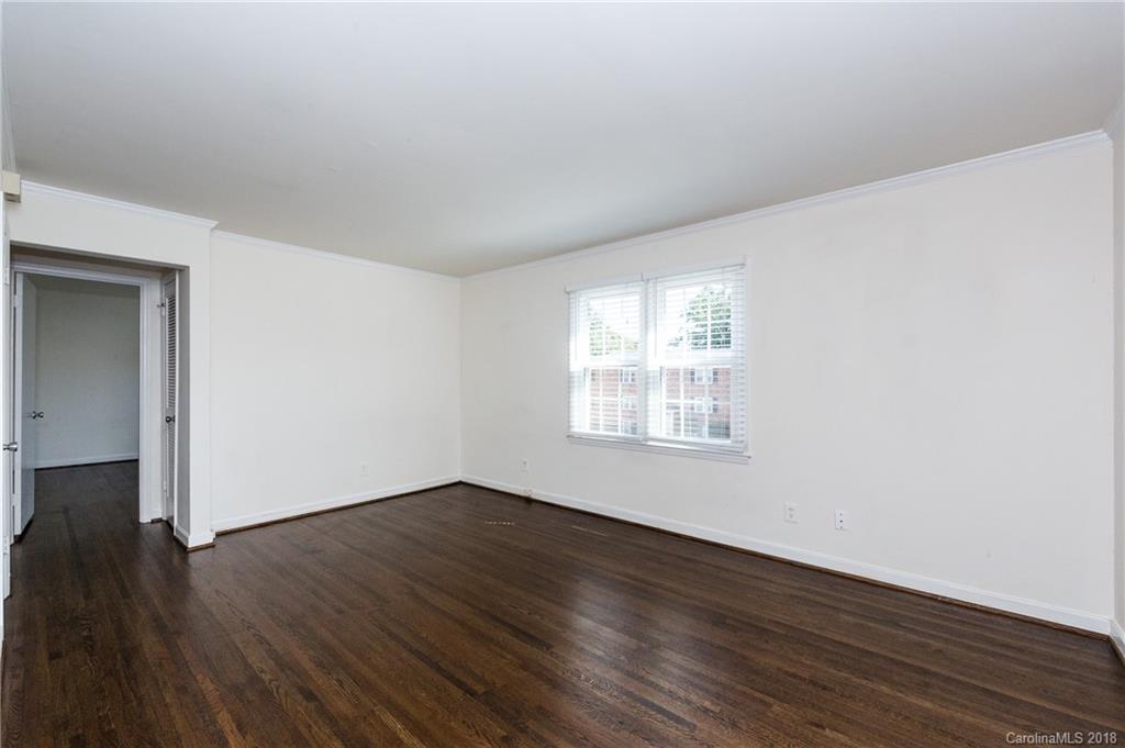 920 McAlway Road, Unit C Charlotte, NC 28211 - Photo 6 of 27 an empty room with wooden floor and windows