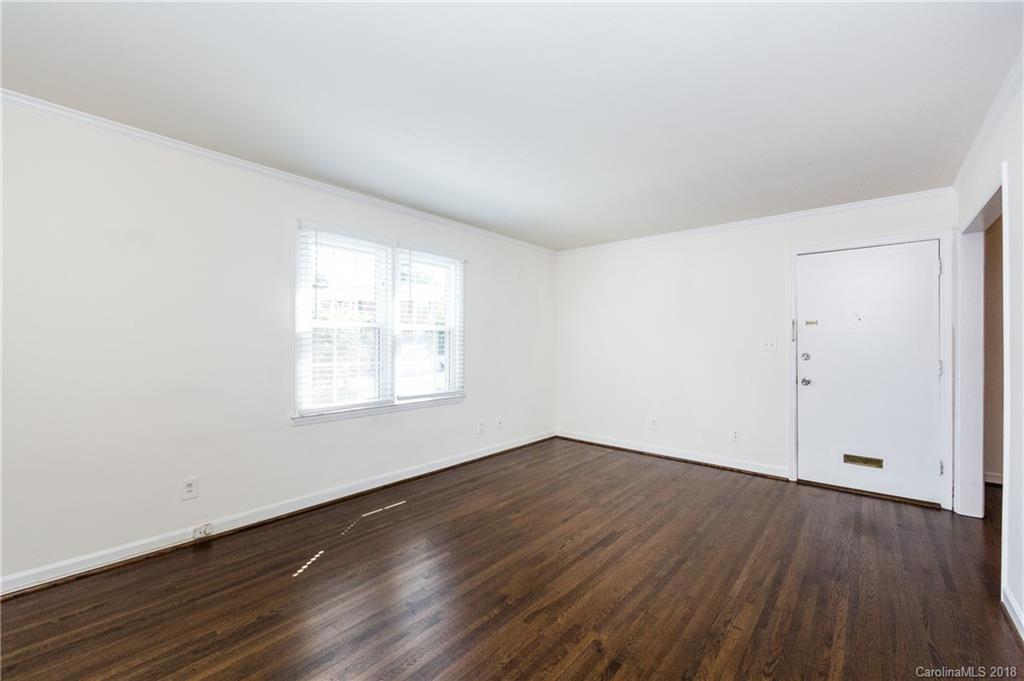 920 McAlway Road, Unit C Charlotte, NC 28211 - Photo 7 of 27 an empty room with wooden floor and windows