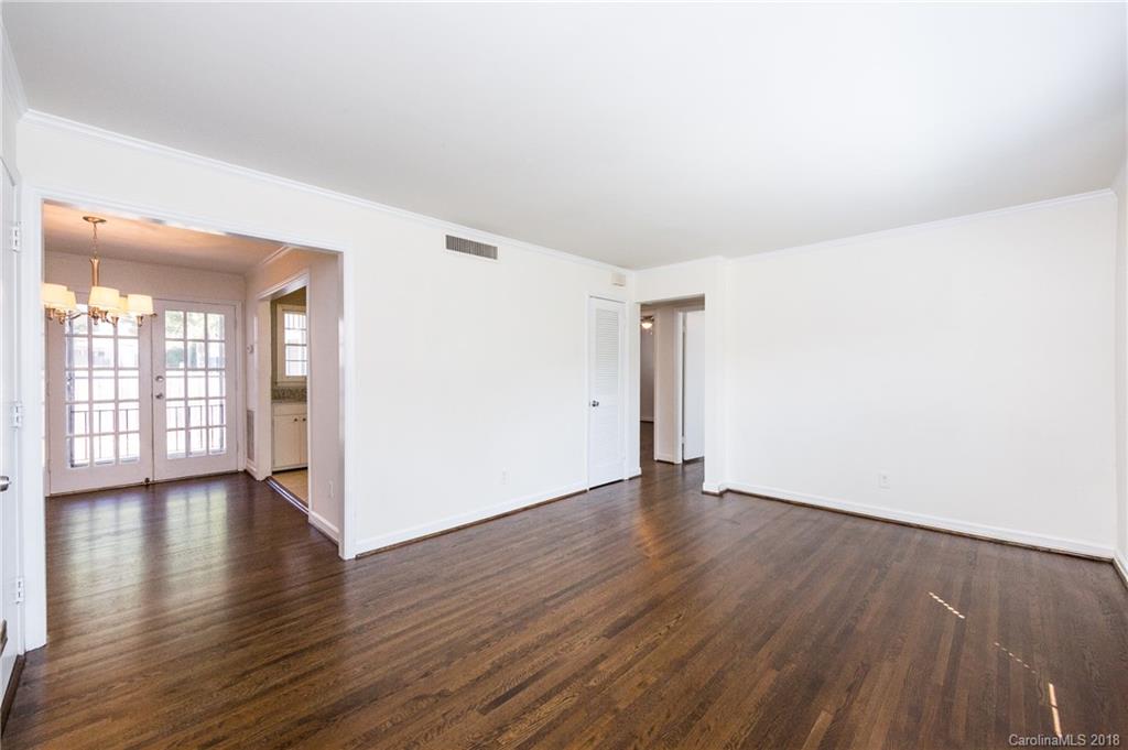 920 McAlway Road, Unit C Charlotte, NC 28211 - Photo 9 of 27 an empty room with wooden floor and windows