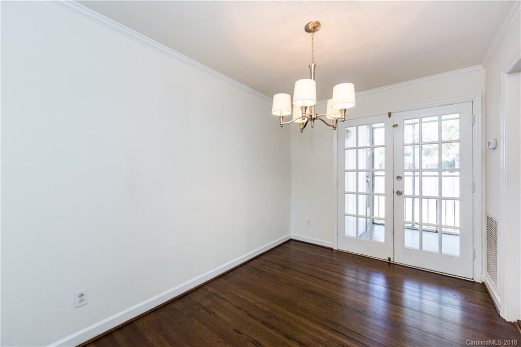 920 McAlway Road, Unit C Charlotte, NC 28211 - Photo 10 of 27 wooden floor in an empty room with a window
