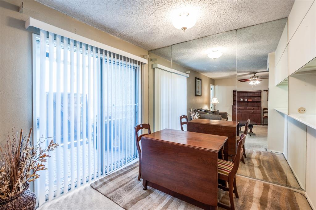 12816 Midway Road, Unit 1066 Dallas, TX 75244 - Photo 11 of 25 a living room with furniture and a large window