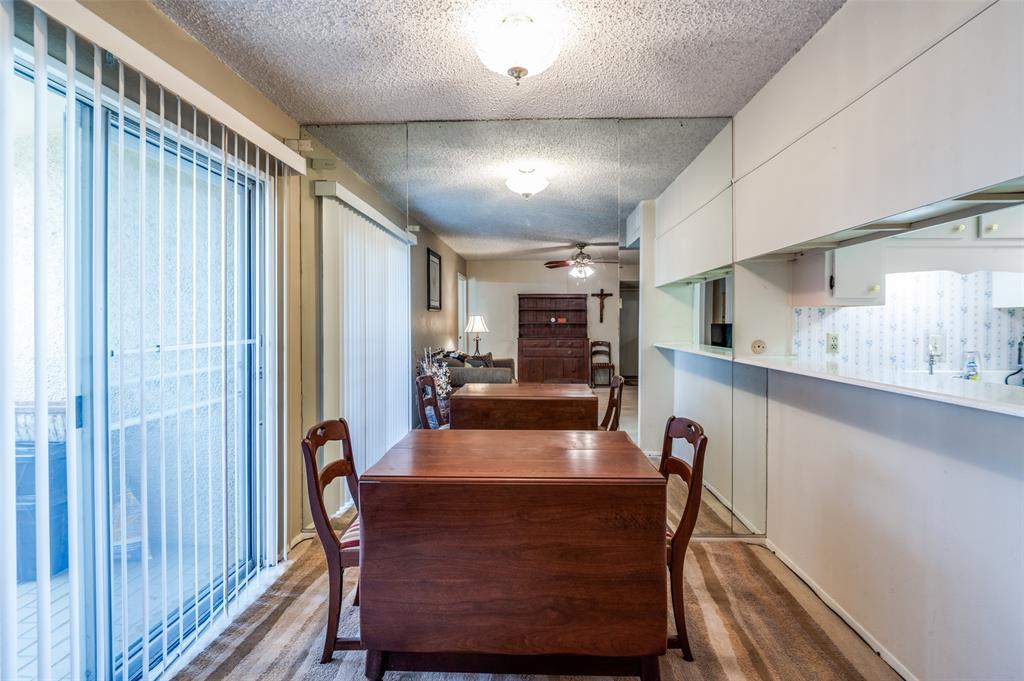 12816 Midway Road, Unit 1066 Dallas, TX 75244 - Photo 13 of 25 a view of a dining room with furniture window and wooden floor