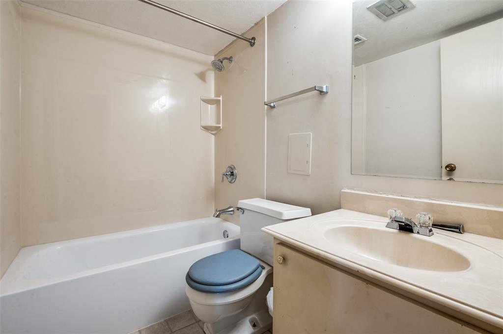 12816 Midway Road, Unit 1066 Dallas, TX 75244 - Photo 14 of 25 a bathroom with a sink toilet and shower
