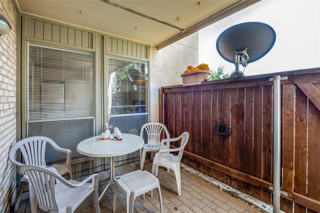 12816 Midway Road, Unit 1066 Dallas, TX 75244 - Photo 22 of 25 a view of a dining room with furniture window and wooden floor