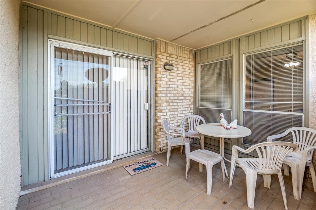 12816 Midway Road, Unit 1066 Dallas, TX 75244 - Photo 23 of 25 a view of a room with a table and chairs