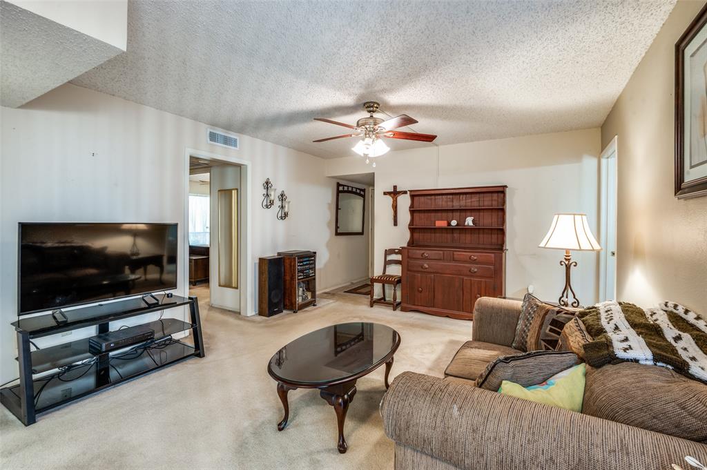 12816 Midway Road, Unit 1066 Dallas, TX 75244 - Photo 3 of 25 a living room with furniture and a flat screen tv