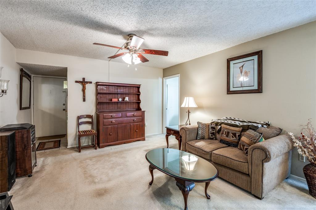 12816 Midway Road, Unit 1066 Dallas, TX 75244 - Photo 5 of 25 a living room with furniture and a flat screen tv