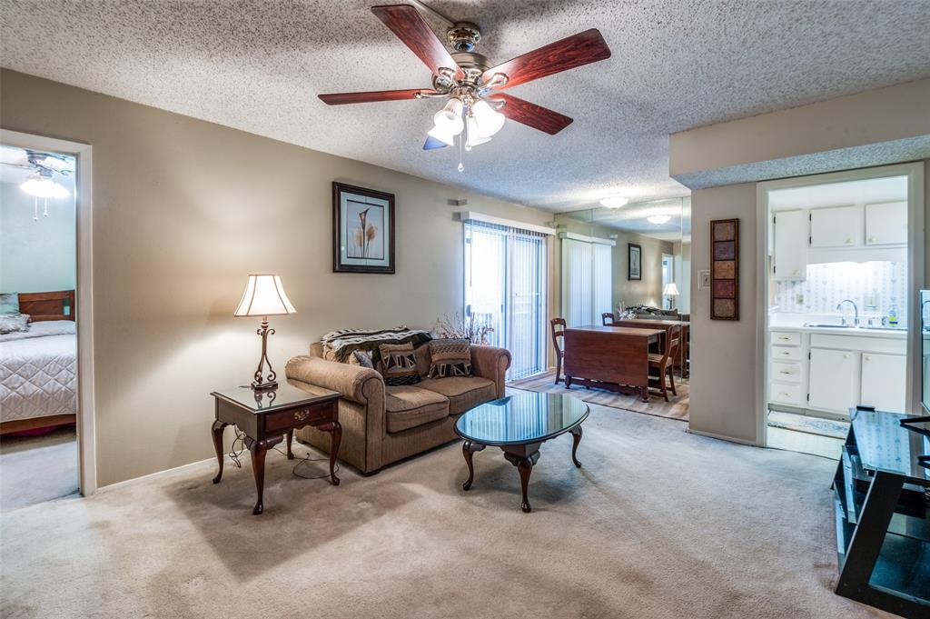12816 Midway Road, Unit 1066 Dallas, TX 75244 - Photo 6 of 25 a living room with furniture and a chandelier