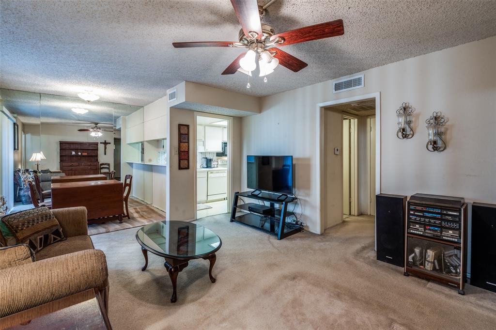 12816 Midway Road, Unit 1066 Dallas, TX 75244 - Photo 7 of 25 a living room with furniture and a flat screen tv