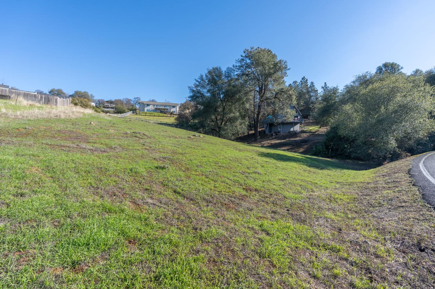 2423 Quail Hill Road Copperopolis, CA 95228 - Photo 14 of 17 a view of a big yard with a house in the background