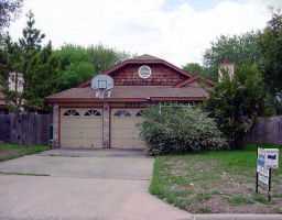 8609 Croydon Loop, Unit N Austin, TX 78748 - Photo 1 of 1 a front view of a house with a yard and garage