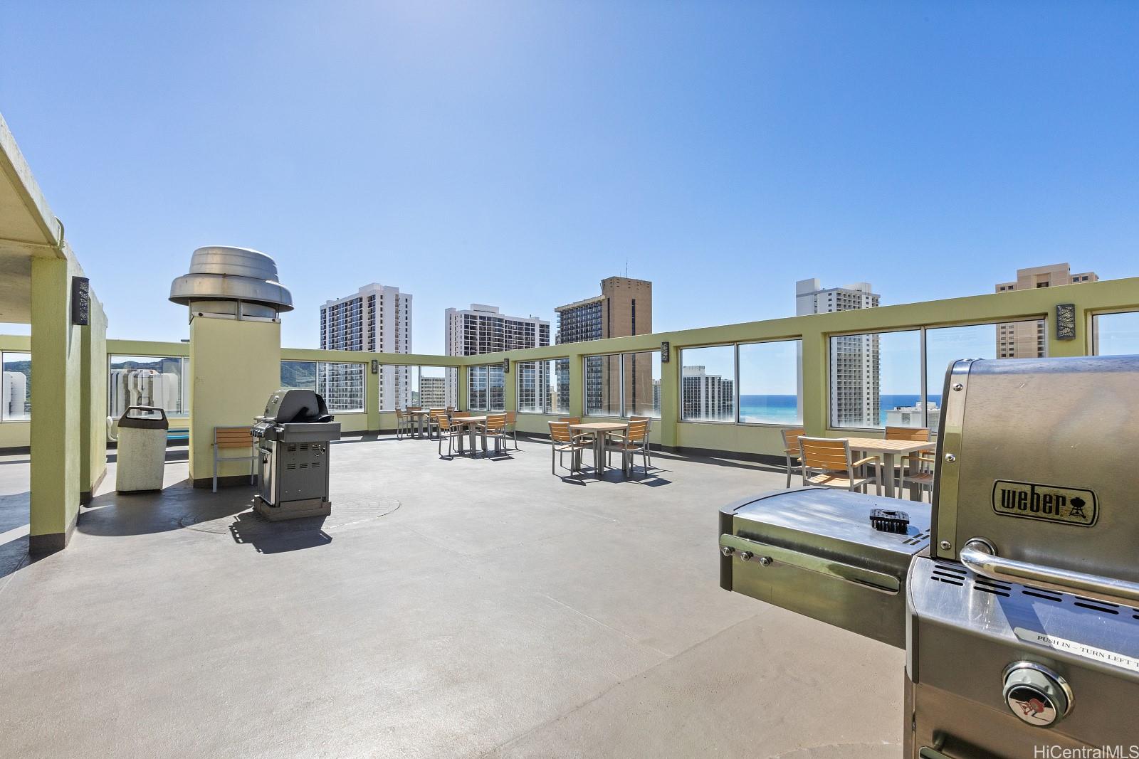 2452 Tusitala Street, Unit 908 Honolulu, HI 96815 - Photo 14 of 19 a view of a livingroom with furniture and a flat screen tv
